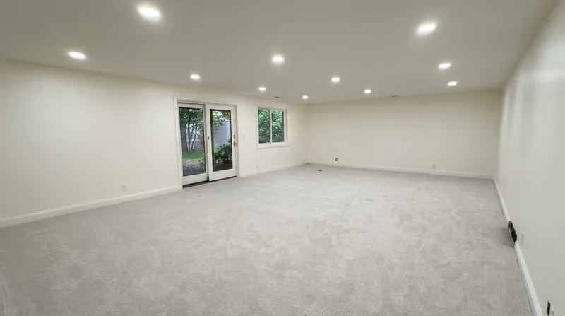 Spacious basement family room with walkout french doors