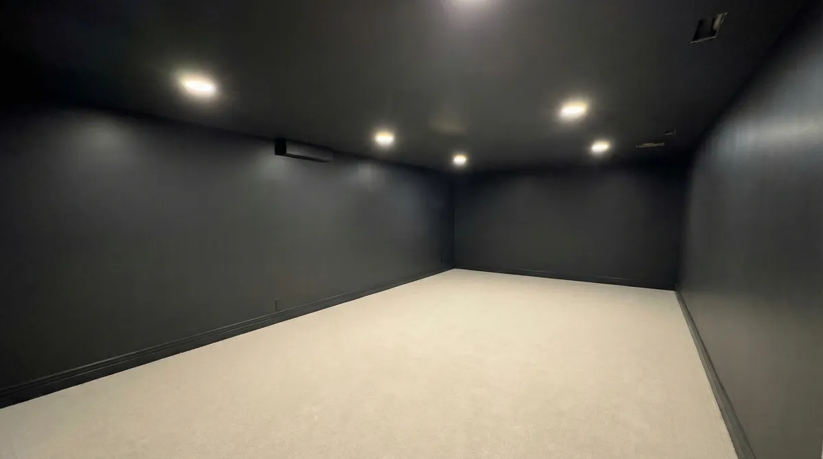 Dedicated home theater room with dark walls