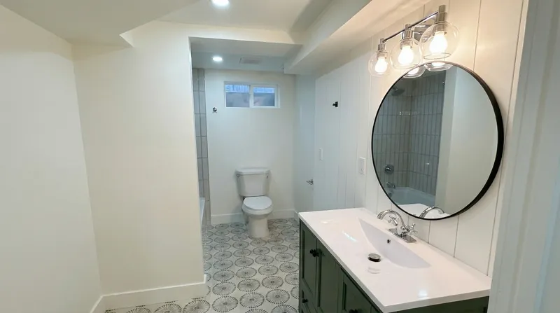 Bathroom with patterned cement tile and green vanity