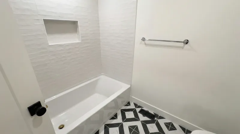 Tub surround with modern tile and built-in niche