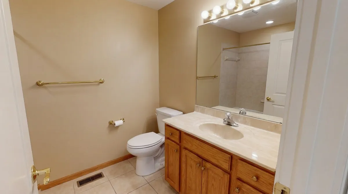 Outdated bathroom with oak vanity before remodel