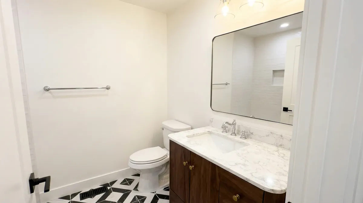 Bathroom with marble vanity and geometric floor tile