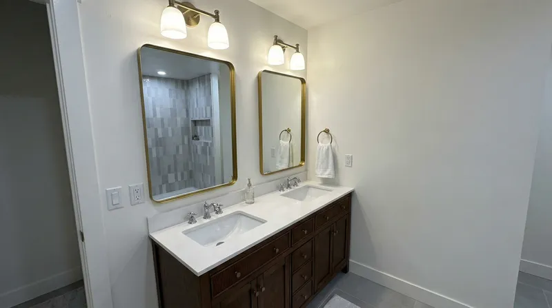 Master bathroom with double vanity and gold mirrors