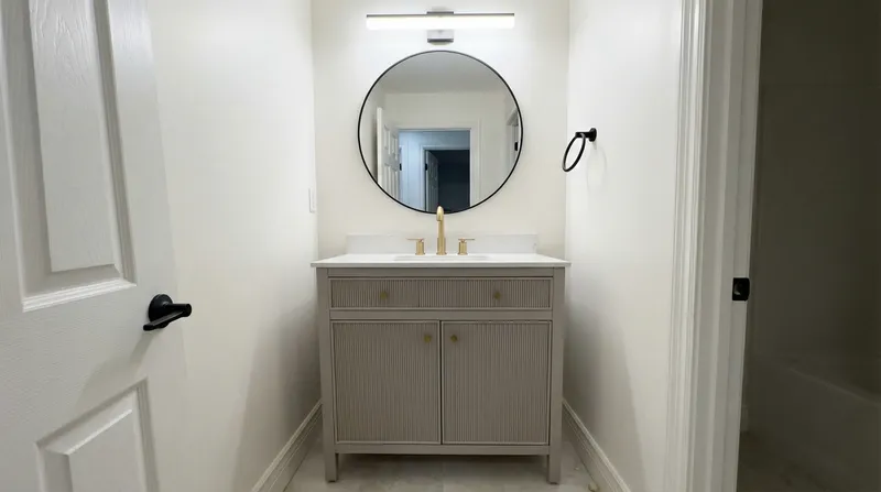 Bathroom with reeded vanity and gold hardware