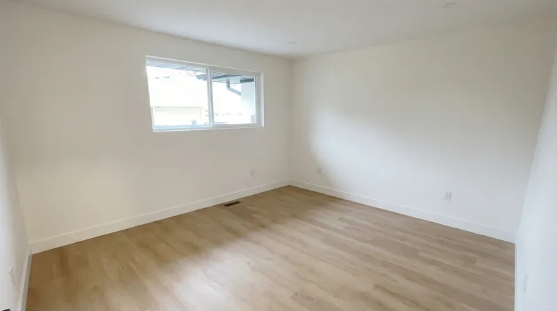 Finished bedroom with window and LVP flooring