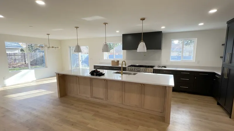 Kitchen island close-up with pendant lights and pro range